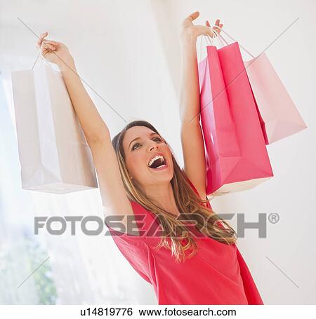 Portrait of young woman with shopping bags View Large Photo Image Stock Photograph - Portrait of young woman with shopping bags. Fotosearch