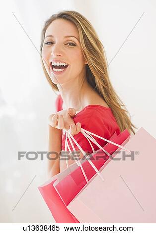 Portrait of young woman with shopping bags View Large Photo Image Stock Photography - Portrait of young woman with shopping bags. Fotosearch