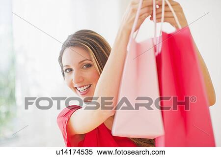 Portrait of young woman with shopping bags View Large Photo Image Stock Photography - Portrait of young woman with shopping bags. Fotosearch