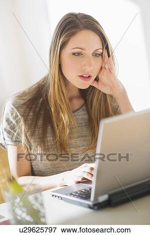Portrait of young woman working with laptop View Large Photo Image Stock Photo - Portrait of young woman working with laptop. Fotosearch