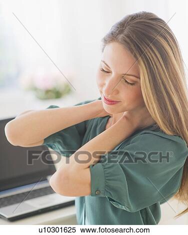 Stock Photography - Portrait of young woman working with laptop. Fotosearch