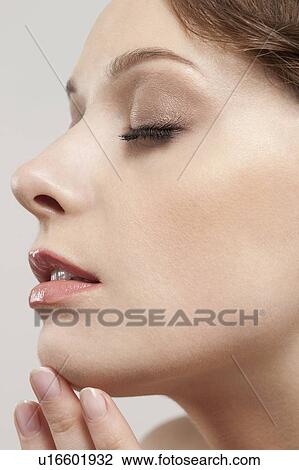 Profile of beautiful young woman with eyes closed, studio shot View Large Photo Image Stock Image - Profile of beautiful young woman with eyes closed, studio shot. Fotosearch