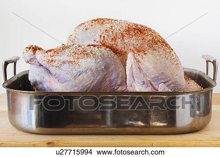 Picture - Raw turkey on roasting pan. Fotosearch