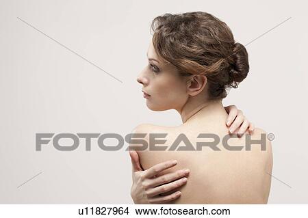Picture - Rear view of beautiful young woman, studio shot. Fotosearch