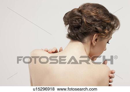 Rear view of beautiful young woman, studio shot View Large Photo Image Stock Photo - Rear view of beautiful young woman, studio shot. Fotosearch