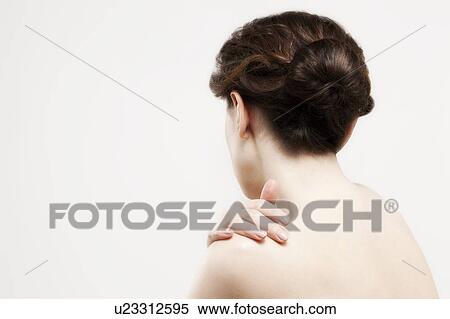 Rear view of beautiful young woman, studio shot View Large Photo Image Stock Photography - Rear view of beautiful young woman, studio shot. Fotosearch