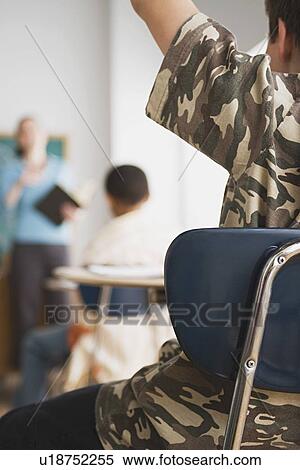 rear view of schoolboy rising hand in classroom View Large Photo Image Stock Photography - rear view of schoolboy rising hand in classroom. Fotosearch