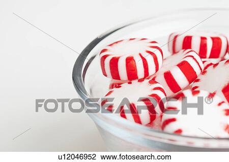 Stock Image - Red and white candies, studio shot. Fotosearch