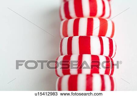 Stock Image - Red and white candies, studio shot. Fotosearch