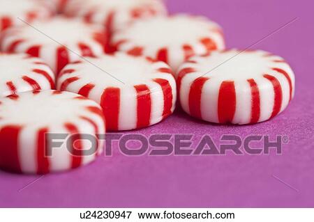 Stock Photo - Red and white candies, studio shot. Fotosearch