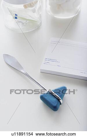 Picture - Reflex hammer on desk. Fotosearch