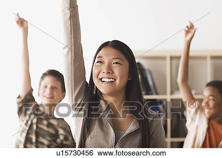 School children rising hands in classroom View Large Photo Image Stock Photograph - School children rising hands in classroom . Fotosearch