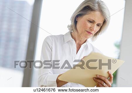 Stock Photograph - Senior businesswoman working. Fotosearch