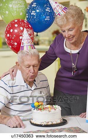 Stock Image - Senior couple celebrating birthday. Fotosearch