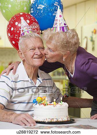 Stock Image - Senior couple celebrating birthday. Fotosearch