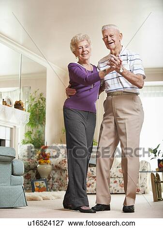 Stock Photo - Senior couple dancing at home. Fotosearch