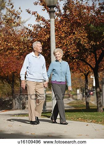 Stock Photograph - Senior couple strolling in park. Fotosearch