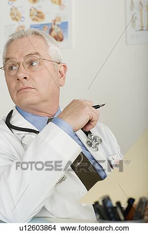 Picture - Senior doctor in office. Fotosearch
