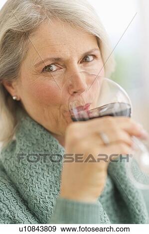 Senior female connoisseur tasting red wine View Large Photo Image Stock Photo - Senior female connoisseur tasting red wine. Fotosearch
