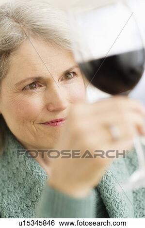 Senior female connoisseur tasting red wine View Large Photo Image Stock Photograph - Senior female connoisseur tasting red wine. Fotosearch