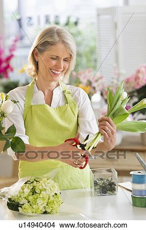 Senior female florist arranging bouquet View Large Photo Image Picture - Senior female florist arranging bouquet. Fotosearch