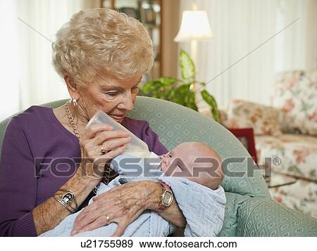 Senior woman giving milk to grandson (2-5 months) View Large Photo Image Stock Photo - Senior woman giving milk to grandson (2-5 months). Fotosearch