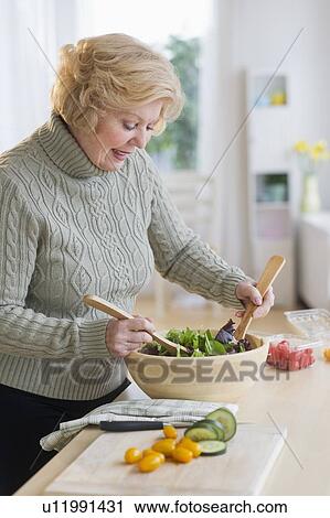 Senior woman preparing salad View Large Photo Image Stock Image - Senior woman preparing salad . Fotosearch