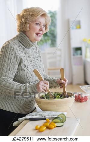 Senior woman preparing salad View Large Photo Image Stock Image - Senior woman preparing salad . Fotosearch