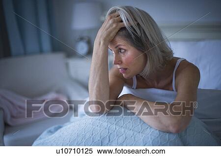 Senior woman sitting in bed and suffering from insomnia View Large Photo Image Stock Photography - Senior woman sitting in bed and suffering from insomnia. Fotosearch