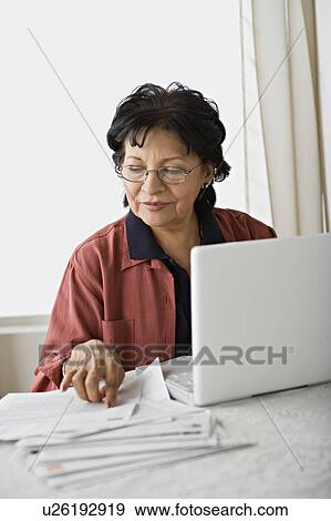 Stock Photo - Senior woman using laptop. Fotosearch
