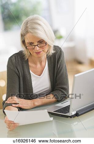 Senior woman working from home View Large Photo Image Stock Photograph - Senior woman working from home. Fotosearch