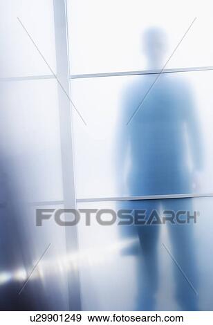Silhouettes of businessman behind glass door View Large Photo Image Stock Photo - Silhouettes of businessman behind glass door. Fotosearch