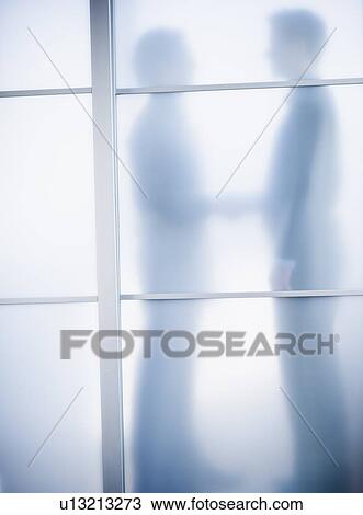 Silhouettes of two businessmen behind glass door View Large Photo Image Stock Image - Silhouettes of two businessmen behind glass door. Fotosearch