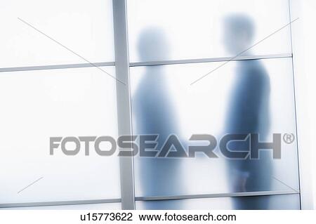 Silhouettes of two businessmen behind glass door View Large Photo Image Stock Image - Silhouettes of two businessmen behind glass door. Fotosearch