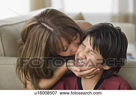 Sister kissing younger brother View Large Photo Image Stock Photo - Sister kissing younger brother. Fotosearch