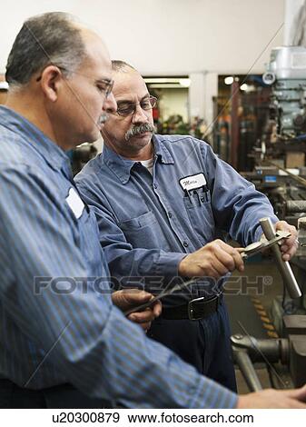 Stock Photo - Skilled workers in factory. Fotosearch