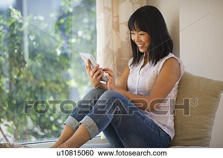 Smiling mid adult woman using digital tablet View Large Photo Image Stock Image - Smiling mid adult woman using digital tablet. Fotosearch