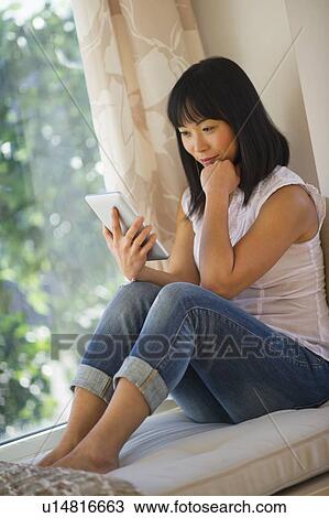 Smiling mid adult woman using digital tablet View Large Photo Image Stock Image - Smiling mid adult woman using digital tablet. Fotosearch