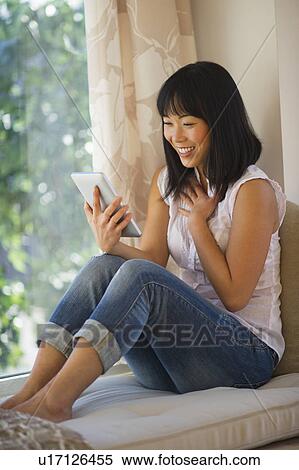 Smiling mid adult woman using digital tablet View Large Photo Image Stock Photography - Smiling mid adult woman using digital tablet. Fotosearch