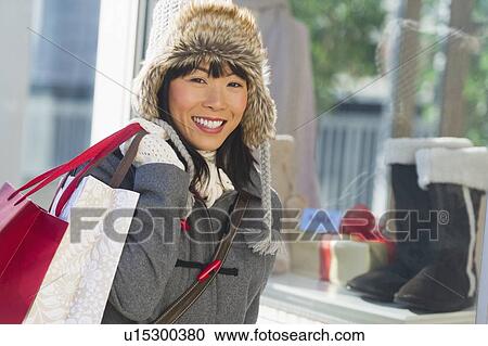 Smiling woman during Christmas shopping View Large Photo Image Stock Image - Smiling woman during Christmas shopping. Fotosearch