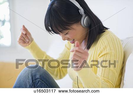 Smiling woman listening music View Large Photo Image Stock Photo - Smiling woman listening music. Fotosearch