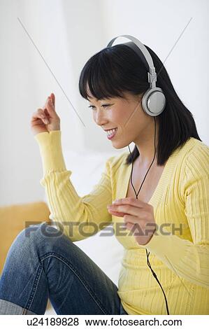 Smiling woman listening music View Large Photo Image Stock Photo - Smiling woman listening music. Fotosearch