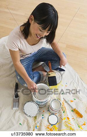 Smiling woman mixing paint View Large Photo Image Stock Image - Smiling woman mixing paint. Fotosearch
