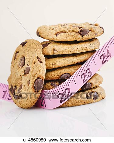 Stack of chocolate chip cookies with measure tape View Large Photo Image Stock Image - Stack of chocolate chip cookies with measure tape. Fotosearch