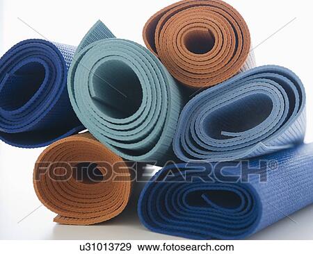 Stock Photo - Stack of exercise mats on white background. Fotosearch