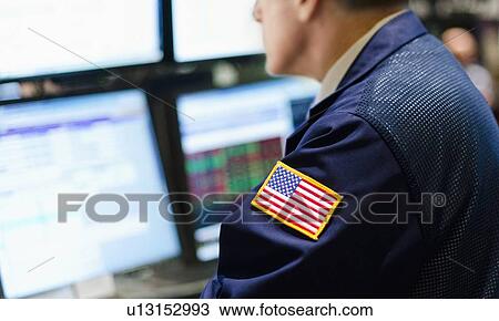 Stock Image - Stock trader with american flag on sleeve. Fotosearch