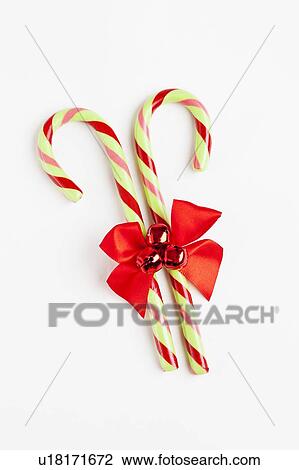 Striped candy canes with red ribbon, studio shot View Large Photo Image Stock Image - Striped candy canes with red ribbon, studio shot. Fotosearch