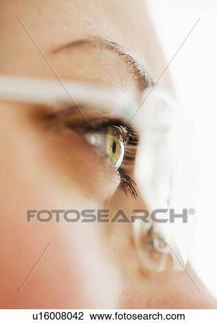 Stock Image - Studio close-up of woman wearing eyeglasses. Fotosearch