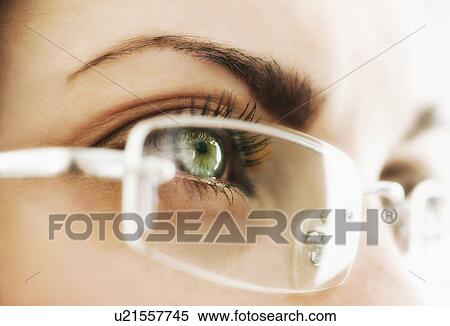 Stock Photography - Studio close-up of woman wearing eyeglasses. Fotosearch