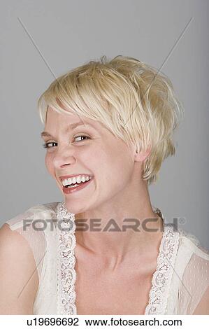 Studio portrait of cheerful young woman View Large Photo Image Stock Image - Studio portrait of cheerful young woman. Fotosearch